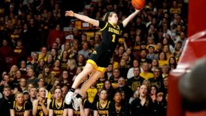 Molly Davis assistant coach standing courtside with Evansville Purple Aces during a game