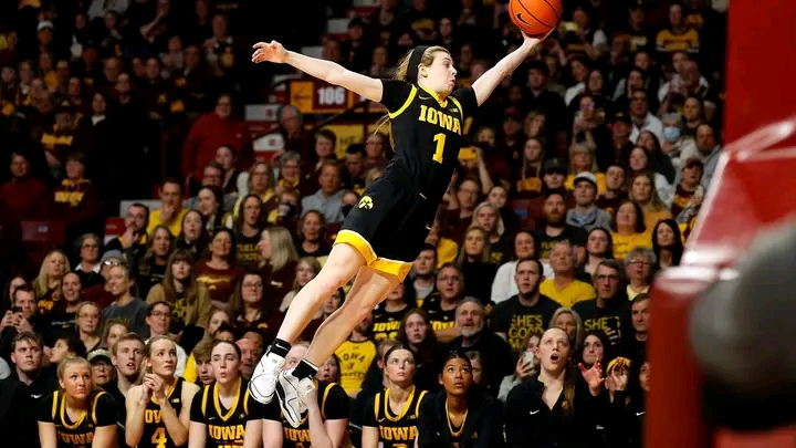 Molly Davis assistant coach standing courtside with Evansville Purple Aces during a game