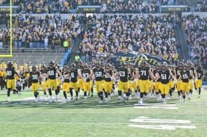 Iowa 2026 schedule predictions: Iowa Hawkeyes players celebrate on the field.